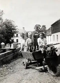 Wrigley Prints: Children on the Wrigley three wheeled motorized cart