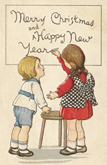 Images Dated 10th September 2012: Children writing Merry Christmas on a board