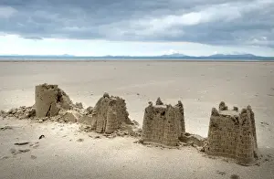 Castles Prints: Childs abandoned sandcastles at low water on Harlech beach