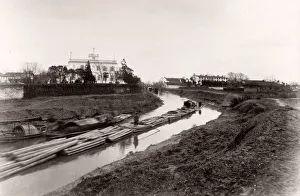 China c. 1880s - floating logs down a canal, Shanghai