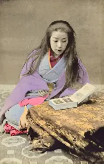 China - Chinese Girl flicking through a Photo Album