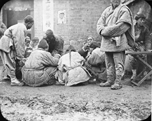 China - men sitting and eating in the street