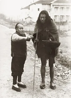 Chinese beggar with bowl and stick, China