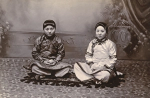 Images Dated 8th February 2016: Two Chinese Girls seated on a small rug