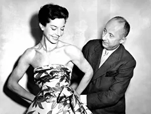 Images Dated 22nd December 2004: Christian Dior with model Dorothy Emms, 1952