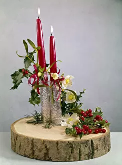 Christmas arrangement of candles, flowers and holly