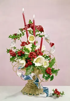 Christmas arrangement of candles, flowers and holly