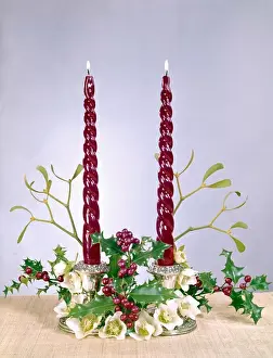 Christmas arrangement of candles, flowers and holly