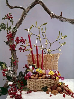 Almond Gallery: Christmas arrangement of candles, holly, mistletoe and nuts