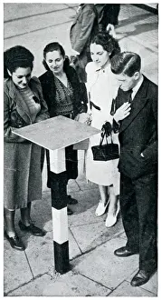 Civilians crowding around a gas-detector table, Sept 1939