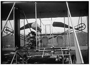 Close-up view of airplane, including the pilot and passenger