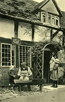 Cobbler at work outside his cottage, Wigmore, Herefordshire