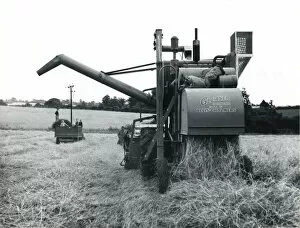 Combine harvester at work in a field, Cornwall