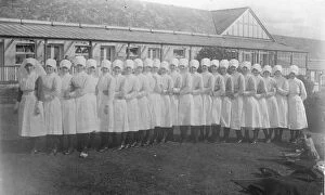 Nursing Gallery: ?Conga? line of 25 nurses, outside single-storey building