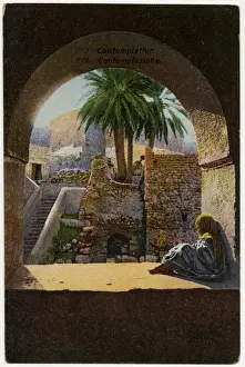 Midday Prints: Contemplation - Young child sits beneath an arch - Tunisia
