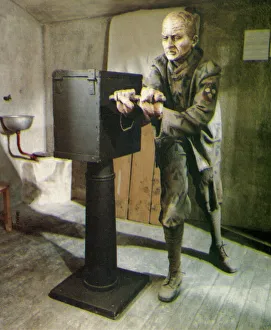 Prison Collection: Convict in prison cell turning hand-crank
