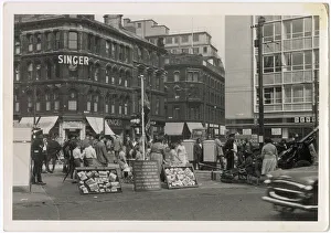 Corner of Market and Bridge Streets, Bradford, West Yorkshire, with Parkinson & Son sewing machines (Singer), Brown Muff & Co, Dentons, and a recruitment drive for the 45 Field Regiment Royal Artillery with a 25 pounder field gun (right)