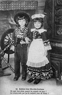Images Dated 12th April 2012: Two country bumpkins posing next to a spinning wheel
