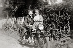 Couple with a 1938 Ariel Red Hunter motorcycle