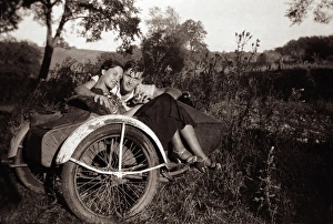 Couple together with 1948 Harley Davidson motorcycle sidecar Couple together with 1948 Harley Davidson motorcycle sidecar