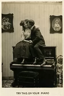 Images Dated 28th September 2012: Couple canoodling on a piano
