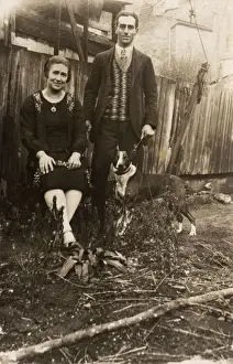 Couple with a dog in a garden