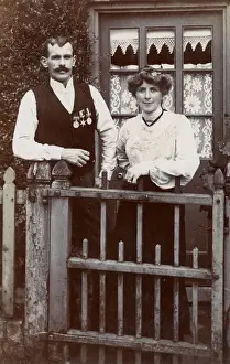 Couple at gate, man wearing Boer War medals