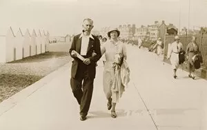 Couple on holiday stroll along the promenade at Felixstowe