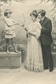 Images Dated 22nd March 2012: Couple pose by cupid statue
