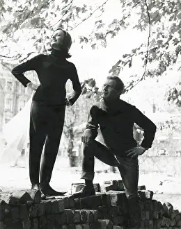 Hanky Prints: A couple pose on a pile of bricks. The woman holds a rather large hanky. Date: late 1960s