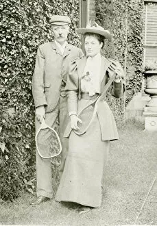 Couple posing with tennis rackets