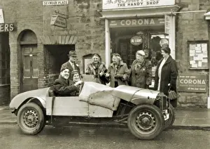 Notice Prints: Couple in ramshackle sports car