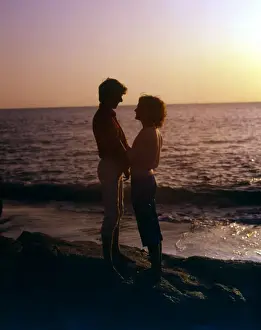 Couple by the sea in the sunset, Cornwall