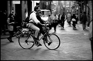 Couple on single bike, Pisa, Italy