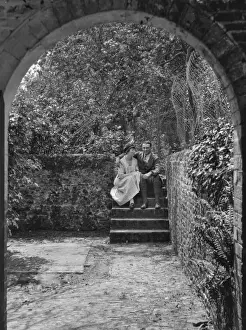 Archway Prints: Couple sitting on steps in a garden, Frensham, Surrey