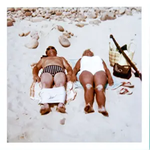 Leisurely Prints: Couple sunbathing on a sandy beach
