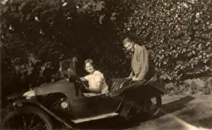 Couple in a tiny three-wheeled car