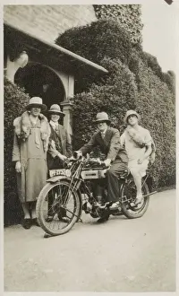 Two Couples having jolly countryside japes - the men are wearing the womens clothing