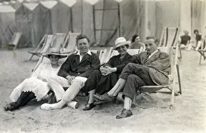 Couples sit in deckchairs on the beach at Margate, Kent