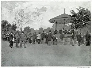 Crowd listening to live music on the bandstand in Battersea Park, London. Date: late 1890s