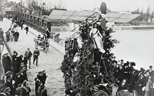 Crowd of People Watch As a Monplane Passes with Pilot on?