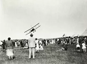 Airshows Collection: A Crowd of People Watching a Biplane Aircraft Flypast wi?