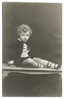 Curly haired boy in photographers studio