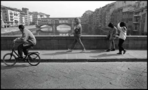 Cyclist, pedestrians, view of Ponte Vecchio, Florence, Italy Cyclist, pedestrians, view of Ponte Vecchio, Florence, Italy