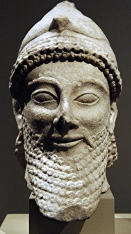 Images Dated 31st May 2008: Cyprus. Limestone male head wearing a helmet with a bird. Ar