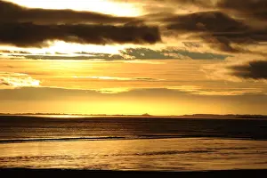Shining Prints: Dark stormy skies above Bamburgh Castle, Northumberland