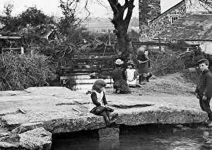 Dartmoor Prints: Dartmoor Children playing on stone bridge early 1900s