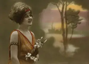 Daydreaming woman holding a bunch of lilies