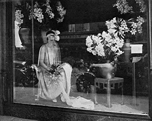 Debutantes Prints: Debutante poses in a shop window, 1928