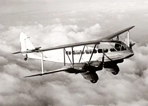 Pre War Prints: DeHavilland biplane airliner in flight, 1934